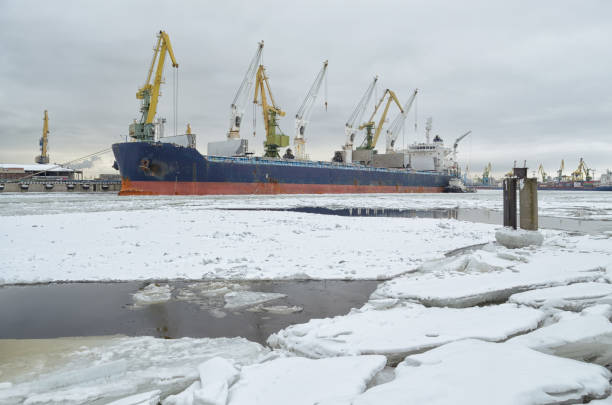 Natural landscape in the cargo port.The water in the Bay is covered with ice.On top is white snow.