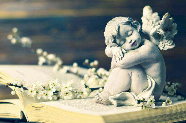 istock Angel guardian sleeping on the book 1128735662