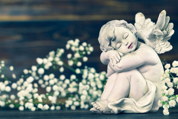 istock Guardian angel and white flowers 1128735683