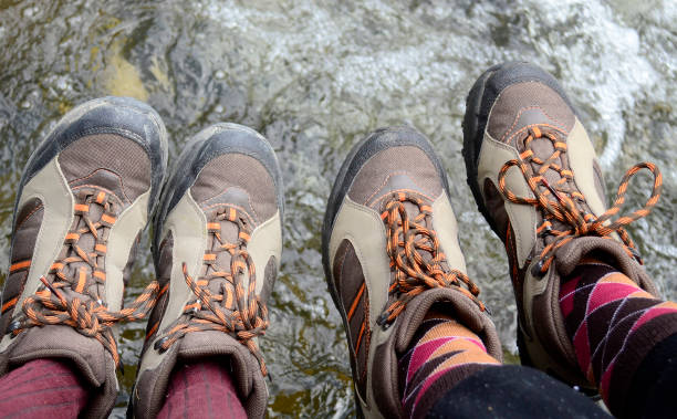 istock Legs of hikers with same boots  hanging 1128735780
