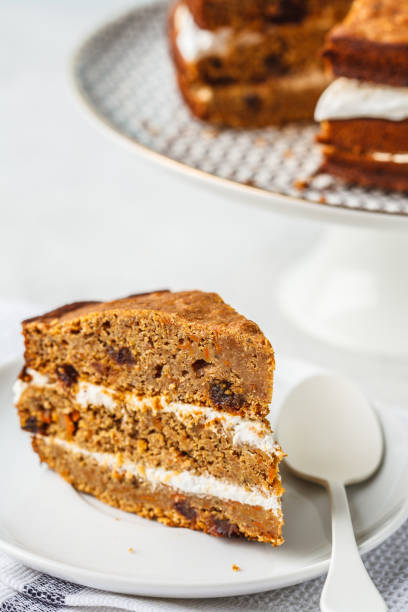 istock Vegan carrot cake with coconut cream, white background. 1128737169