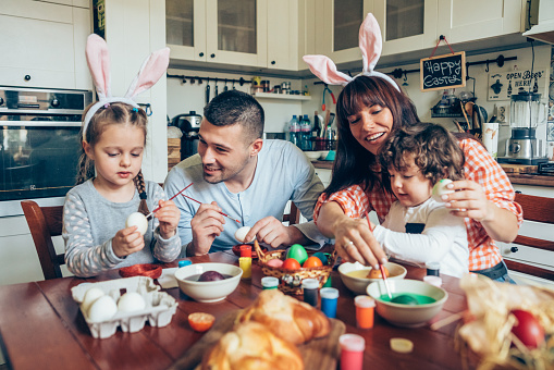 Lovely family prepare for Easter at domestic kitchen