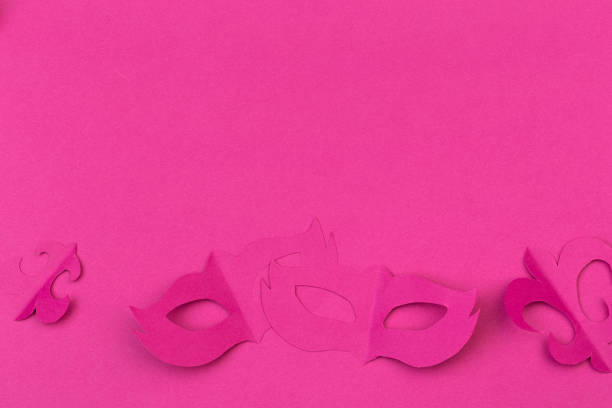 istock cut out colored paper figures for the holiday Mardi Gras, colour background 1128742071