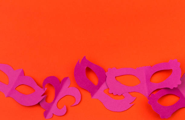 istock cut out colored paper figures for the holiday Mardi Gras, colour background 1128742092