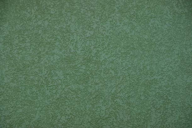 istock green texture of plaster with a pattern on the wall 1128744824
