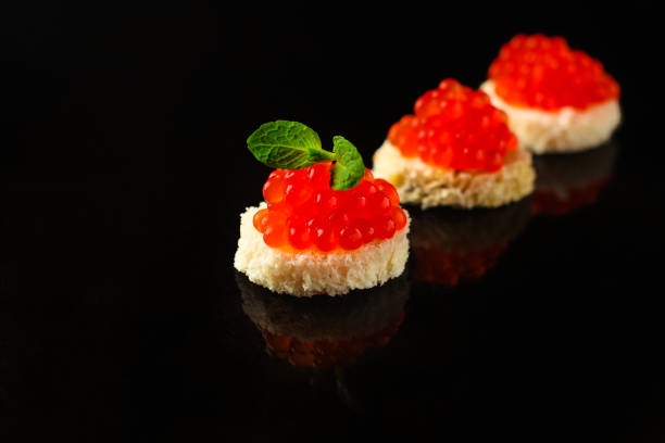 istock red caviar (canapés or a red snack sandwich). food background. top view 1128745975