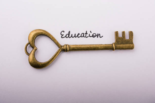 istock Education wording beside a retro style key on white background 1128746077
