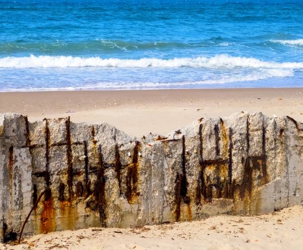 istock Reinforced concrete structure on the beach, collapsing from moisture and corrosion 1128746230