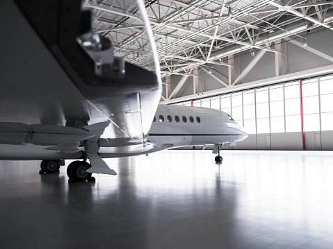 Luxorious business jet plane Dassault Falcon is being stored inside the hangar