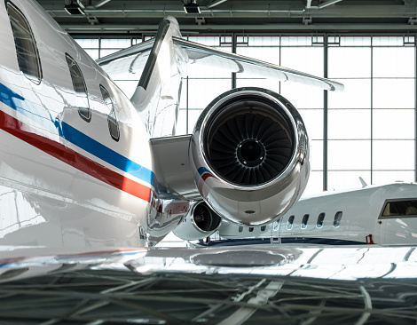 Luxorious business jet planes bombardier challenger and gulfstream are being stored inside the hangar