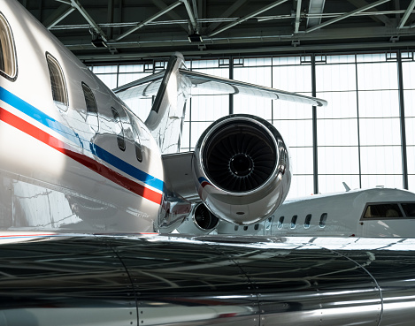 Luxorious business jet planes bombardier challenger and gulfstream are being stored inside the hangar