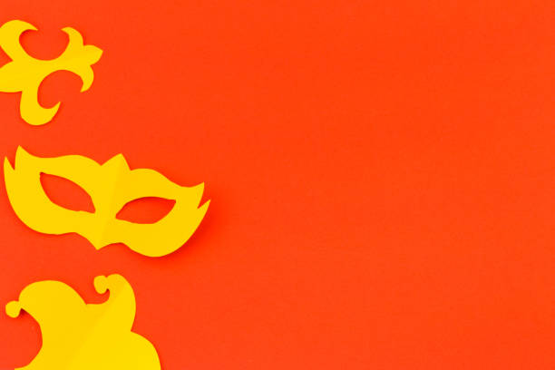 istock cut out colored paper figures for the holiday Mardi Gras, colour background 1128747337