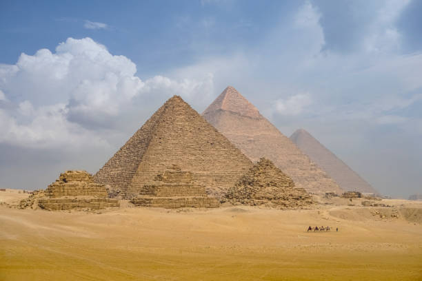 istock The camel caravan is in front of the Egyptian pyramids. 1128748931