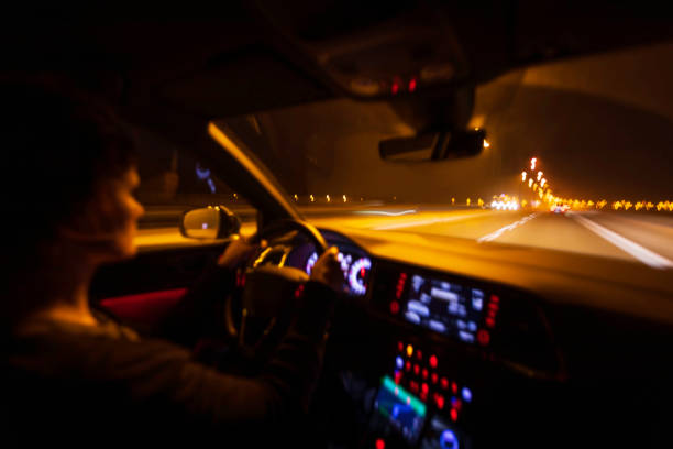 istock woman is driving a car at night 1128750642