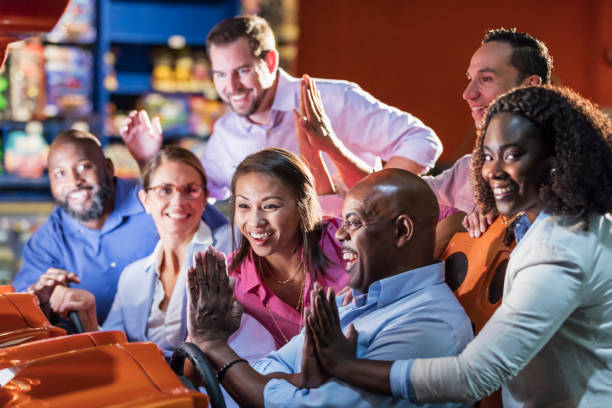 istock Team building at amusement arcade, playing racing game 1128751239