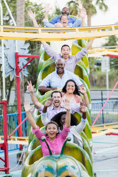 istock Corporate team building on amusement park rollercoaster 1128751900