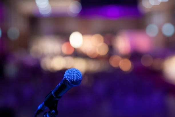 istock microphone in concert hall or conference room soft and blur style for background. 1128754132