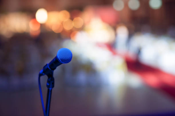 istock microphone in concert hall or conference room soft and blur style for background. 1128754655
