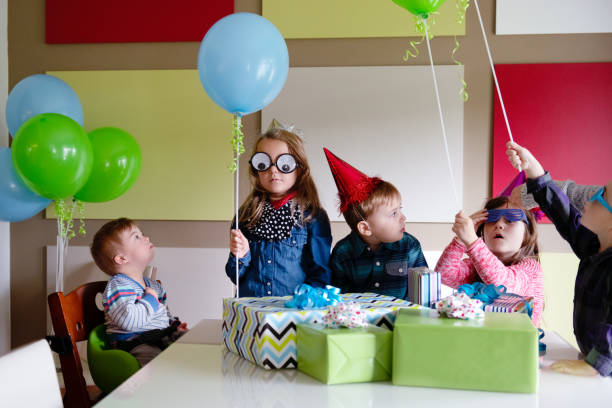 istock Birthday party with little boy with down syndrome 1128755794