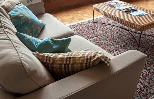istock Corner of a comfy couch with pillows 1128755979
