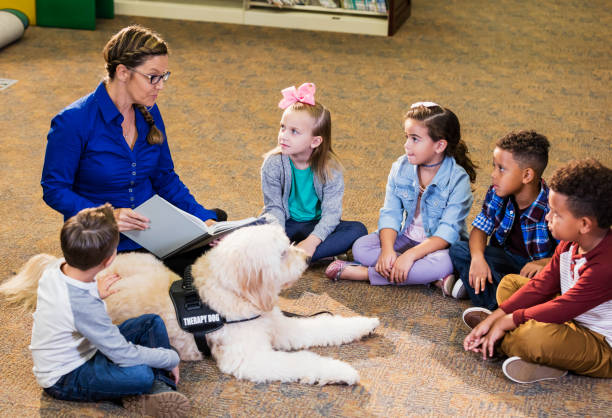 istock Children in library with reading assistance dog 1128756159