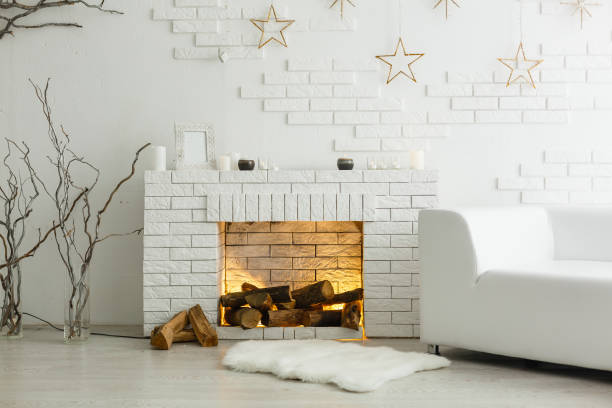 white fireplace in light room with christmas decoration - fire place imagens e fotografias de stock