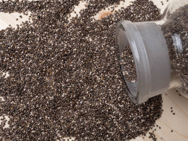 istock chia seeds in glass bottle on wooden table 1128757452