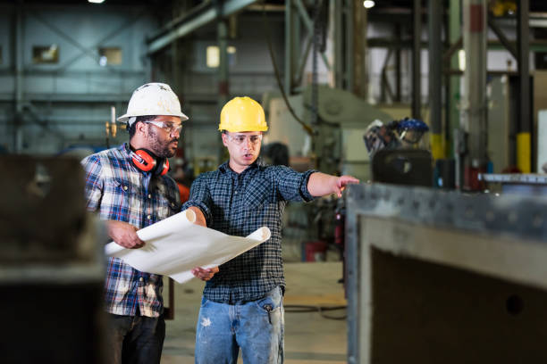 istock Multi-ethnic workers talking in metal fabrication plant 1128759986