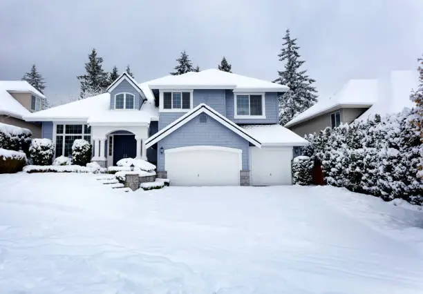 Rare snow storm in Northwest United States with residential home in background Rare snow storm in Northwest United States with residential home in background
