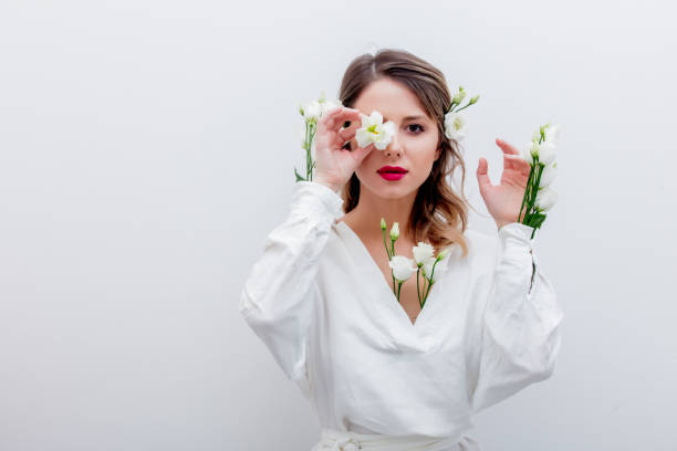 istock Beautiful woman with white roses in sleeve 1128762401