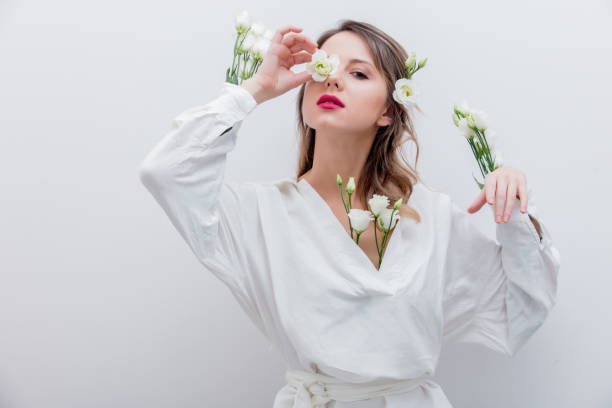 istock Beautiful woman with white roses in sleeve 1128762409