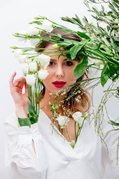 istock Beautiful woman with white roses in sleeve 1128762424