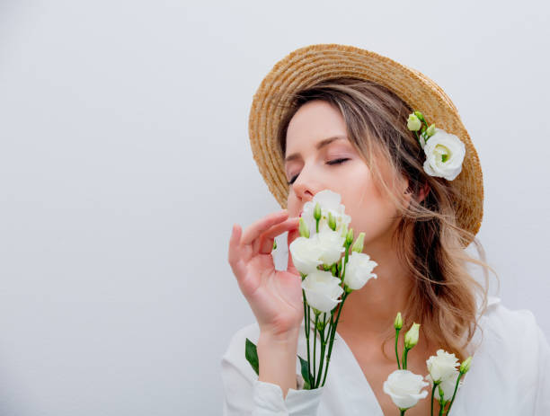 istock Beautiful woman with white roses in sleeves 1128762455