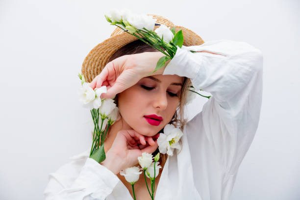istock Beautiful woman with white roses in sleeves 1128762461