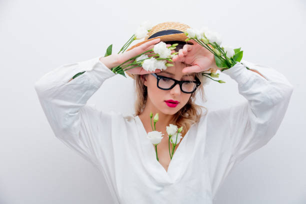 istock Beautiful woman with white roses in sleeves 1128762468