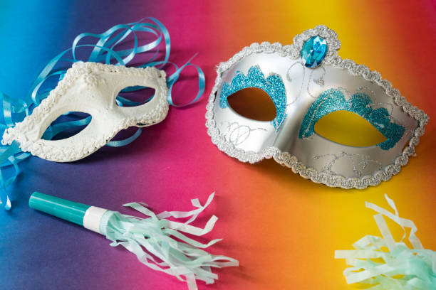 carnival masks on rainbow colored background