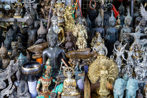 Collection of statues is displayed, featuring various figures, Buddhas and deities - Thai Pass