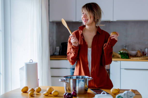 istock housewife with pot cooking on kitchen. 1128765886