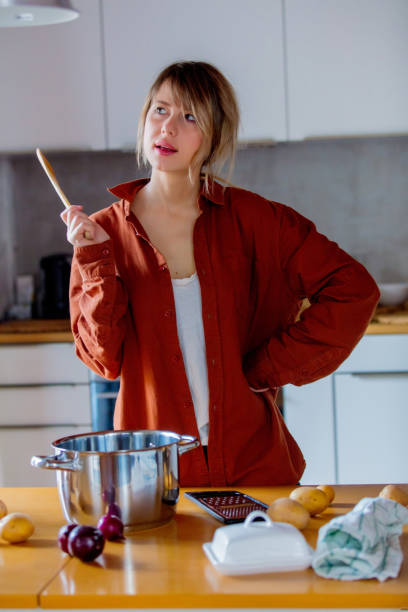 istock housewife with pot cooking on kitchen. 1128765903