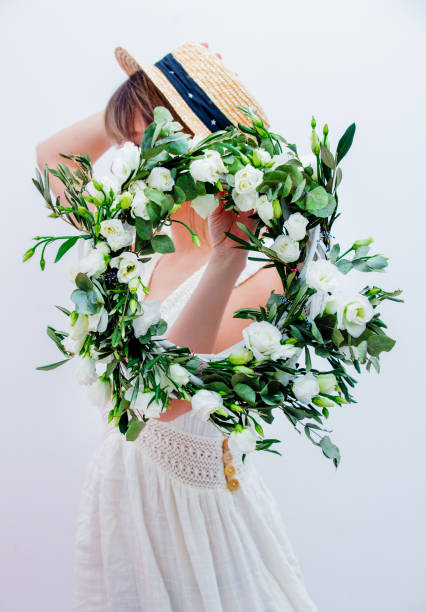 istock Beautiful woman with white roses wreath on white background 1128765909