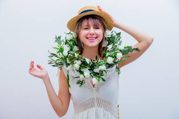 istock Beautiful woman with white roses wreath on white background 1128765912