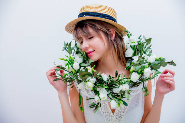 istock Beautiful woman with white roses wreath on white background 1128765932