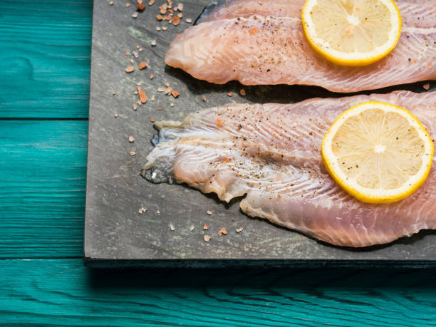 istock Red perch fillet on green marble board 1128767046
