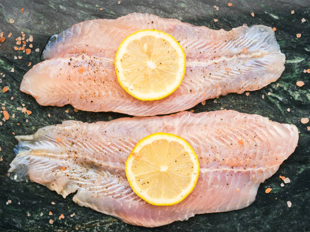 istock Red perch fillet on green marble board 1128767051