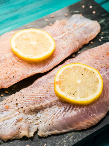 istock Red perch fillet on green marble board 1128767056