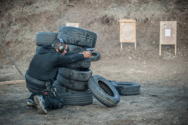 istock Combat gun tactical shooting behind and around cover or barricade 1128767767