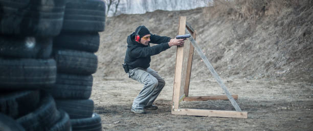 istock Combat gun tactical shooting behind and around cover or barricade 1128768725