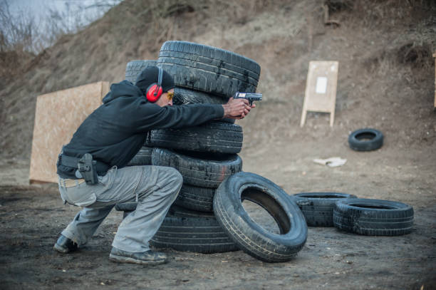istock Combat gun tactical shooting behind and around cover or barricade 1128769068