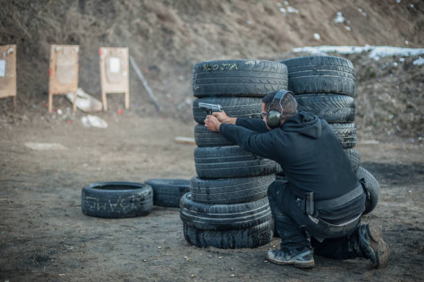 istock Combat gun tactical shooting behind and around cover or barricade 1128769176