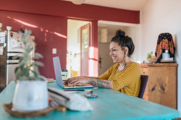 Successful Tattooed Latina freelancer working from home